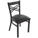 A black metal Lancaster Table & Seating chair with a black cushion.