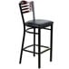 A black bar height chair with a wooden back and black cushion.