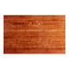 A close up of a Lancaster Table & Seating solid wood table top with a rustic mahogany finish.