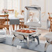 An Acopa stainless steel chafer with food on a table.
