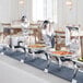 An Acopa stainless steel chafer with food on a table.