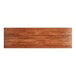 A Lancaster Table & Seating wooden rectangular table top with a rustic mahogany finish.