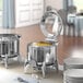 A buffet line with an Acopa Voyage stainless steel chafer on a table.