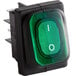 A green light on a black Avantco power switch.