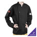 A person wearing a Chef Revival black long sleeve chef coat over a white shirt.