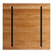 A Lancaster Table & Seating solid wood live edge table top with a honey maple finish and black metal bars.