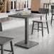 A Lancaster Table & Seating live edge table with chairs and a tray of food on it.