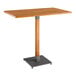 A Lancaster Table & Seating wooden table with a metal base.