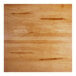 A close up of a Lancaster Table & Seating live edge wood table top with a honey maple finish.