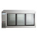 An Avantco stainless steel back bar refrigerator with three narrow sliding glass doors.