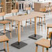 A Lancaster Table & Seating live edge wood bar height table with chairs.