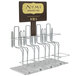 A metal Numi tea rack on a counter with four types of tea.