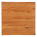 A Lancaster Table & Seating square wood bar height table with an antique natural finish.
