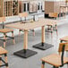 A Lancaster Table & Seating live edge wood table with chairs and a bench.