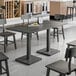 A Lancaster Table and Seating solid wood table with chairs in a room.