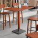 A Lancaster Table & Seating live edge table with chairs in a restaurant dining area.