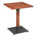 A Lancaster Table & Seating square wooden table with a black metal base.