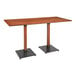 A Lancaster Table & Seating live edge bar height table with metal legs.