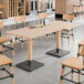 A Lancaster Table & Seating solid wood table with a live edge and bleached oak finish.