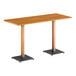A Lancaster Table & Seating bar height table with a live edge wooden top and two legs.