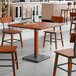 A Lancaster Table & Seating wooden table with metal legs.