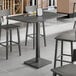 A Lancaster Table & Seating live edge table with a slate gray finish.