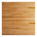 A square solid wood bar height table top with a honey maple finish and a live edge design.