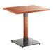 A Lancaster Table & Seating solid wood table with a live edge and metal base.