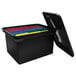 A black plastic file storage bin with colorful files inside.