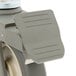 A close-up of a MetroMax iQ grey swivel stem caster wheel with brake.