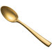 A close-up of a Bon Chef gold stainless steel soup/dessert spoon with a long handle.