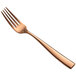 A close-up of a rose gold Bon Chef European dinner fork.