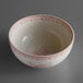 A white Oneida porcelain bowl with a pink and red floral design.