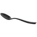 A black stainless steel teaspoon with a curved handle.