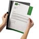 A person holding a Durable clear and graphite report cover with a document inside.