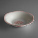 a white bowl with red designs