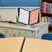 A Durable InstaView desktop reference system on a table with a document folder in it.