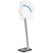 A white metal stand with a blue arrow pointing to the right and a white sheet of paper on it.