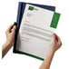 A person's hands holding a navy blue Durable DuraClip report cover with a document inside.