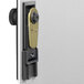 A brushed aluminum Durable key cabinet with a black and silver lock on the door.