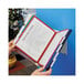 A person holding a Durable 10 panel desktop reference system folder with documents.
