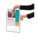 A person holding a Durable 10 panel desktop reference system.