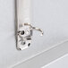 A brushed aluminum Menu Solutions table tent with a silver metal hook.