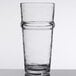 A close-up of a Libbey Tritan plastic beverage glass with a curved rim.
