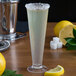 A Libbey Tritan plastic dessert shot glass with liquid and a lemon slice on top.