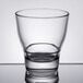 An Arcoroc Urbane stackable double old fashioned glass on a reflective surface.