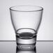 An Arcoroc stackable rocks glass on a reflective surface.