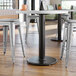 A Lancaster Table & Seating black cast iron table base with stools.