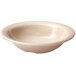 A white bowl with a beige speckled surface.