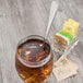 An iced tea glass with a stainless steel Oneida Baguette spoon in it.